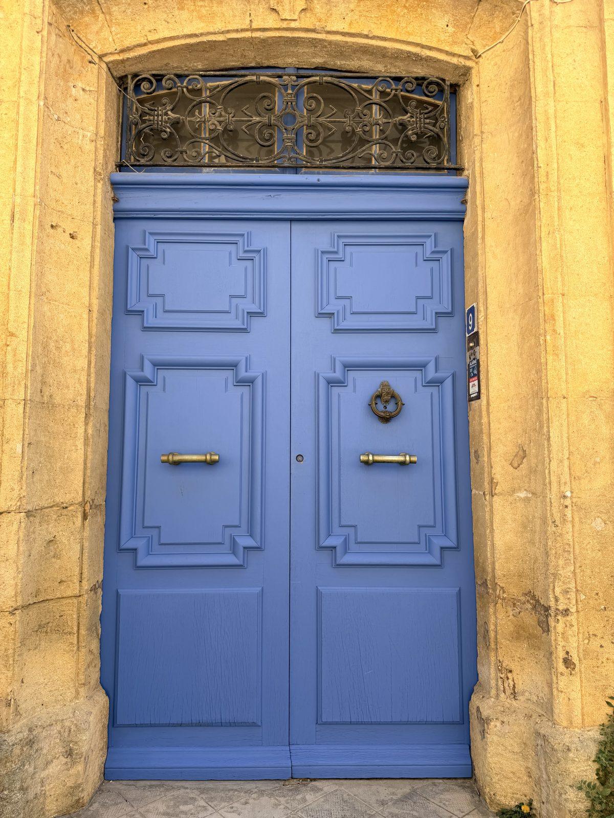 A blue door in a stone wall